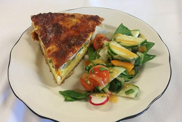 On the plate, you can see a tart and a salad